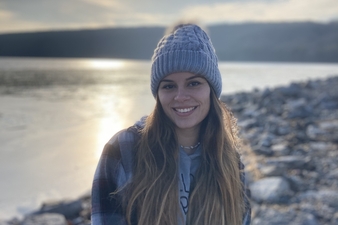 Danielle Bosche standing on the shore of a lake